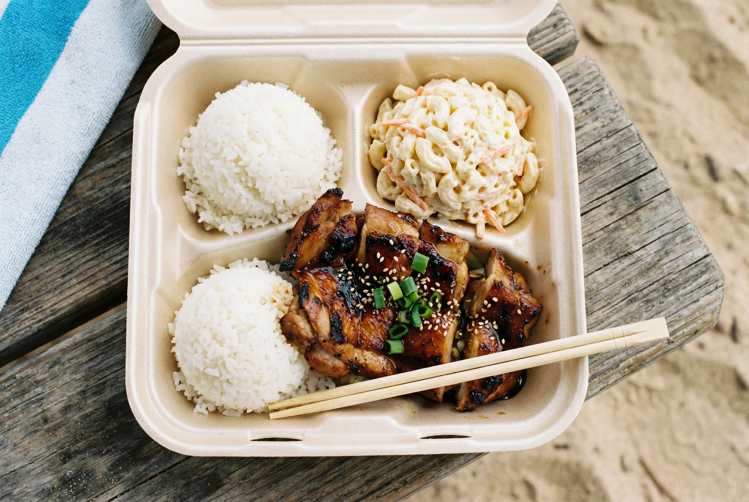 Classic Hawaii plate lunch features two scoops rice, macaroni salad, and protein - the ultimate local comfort food Hawaii plate lunch with two scoops rice macaroni salad and teriyaki chicken