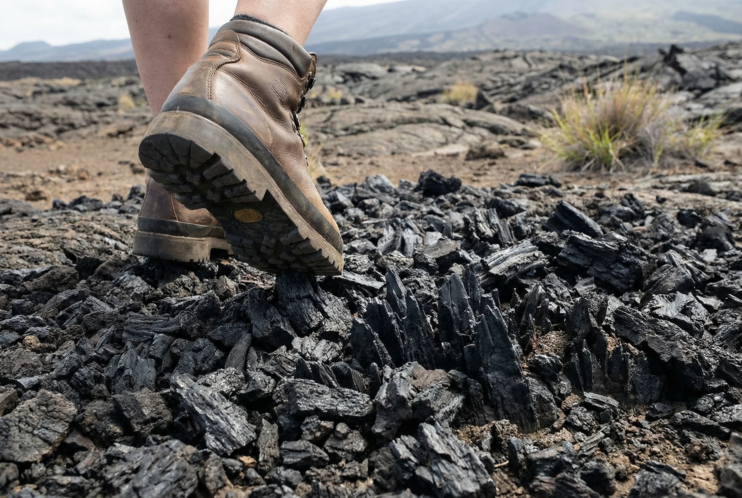 Sharp aa lava requires sturdy closed-toe shoes - essential safety gear for Big Island hiking and volcano exploration Hiking on sharp aa lava rock with proper closed-toe shoes on Big Island Hawaii